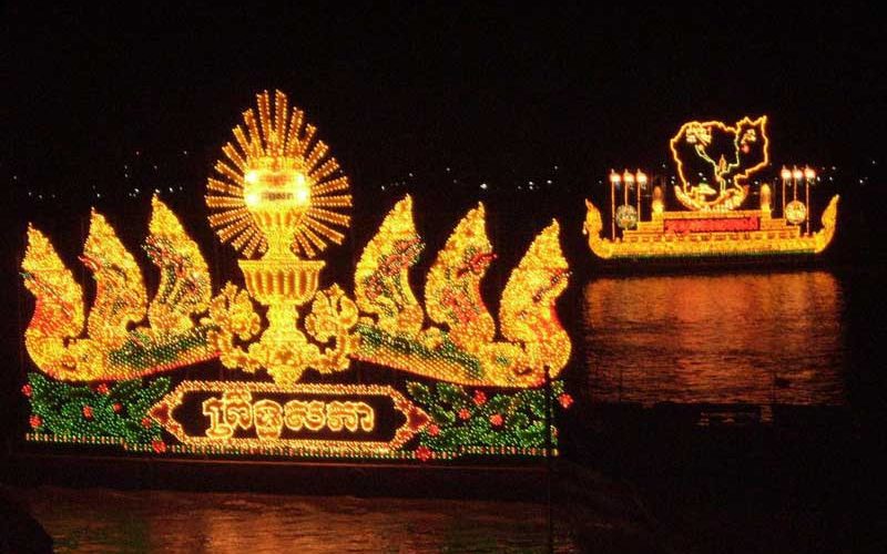 Bateaux-lanternes richement illuminés flottant sur le fleuve la nuit lors du Festival Bon Om Touk au Cambodge