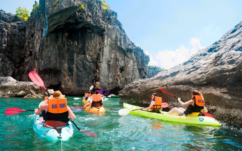 Kayak de mer au parc national marin d’Ang Thong, avec des visiteurs pagayant entre des falaises calcaires spectaculaires et une eau turquoise