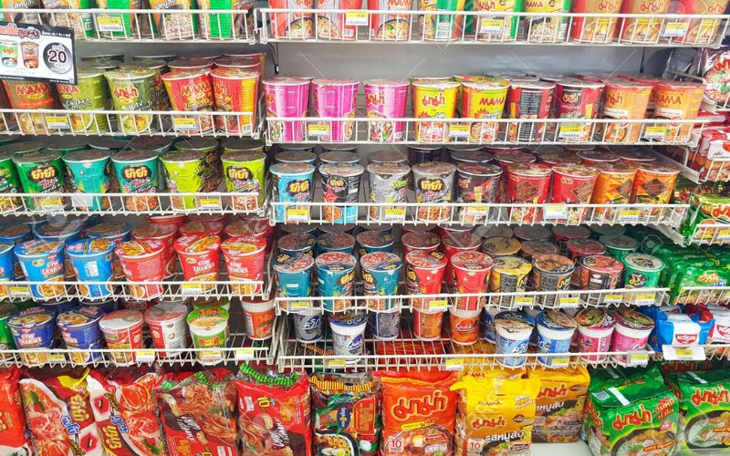 Rayon de 7-Eleven en Thaïlande rempli de nouilles instantanées de différentes marques et saveurs, dont Mama, Nissin et autres formats en coupelles et sachets