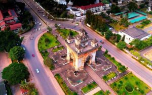 Vue aérienne spectaculaire du Patuxai, le monument emblématique de Vientiane, Laos, situé au centre d’un rond-point verdoyant, entouré de jardins bien entretenus et de larges avenues